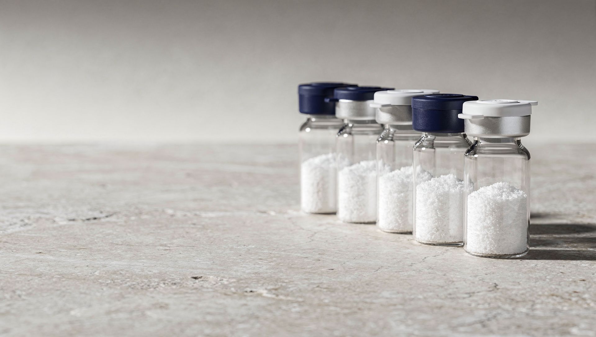 Research vials arranged on a pale laboratory surface
